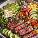 Healthy Steak Power Bowl with avocado, tomatoes, corn, and cucumber.