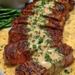 Slices of tender garlic butter steak bites smothered in a rich cream sauce and garnished with fresh parsley