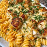 Delicious creamy garlic butter chicken pasta recipe served on a white plate.